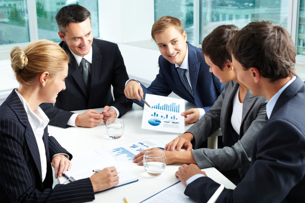 Summing up the results Positive business people holding a meeting to sum up the results of the year