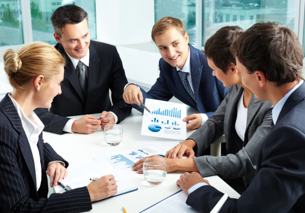 Summing up the results Positive business people holding a meeting to sum up the results of the year